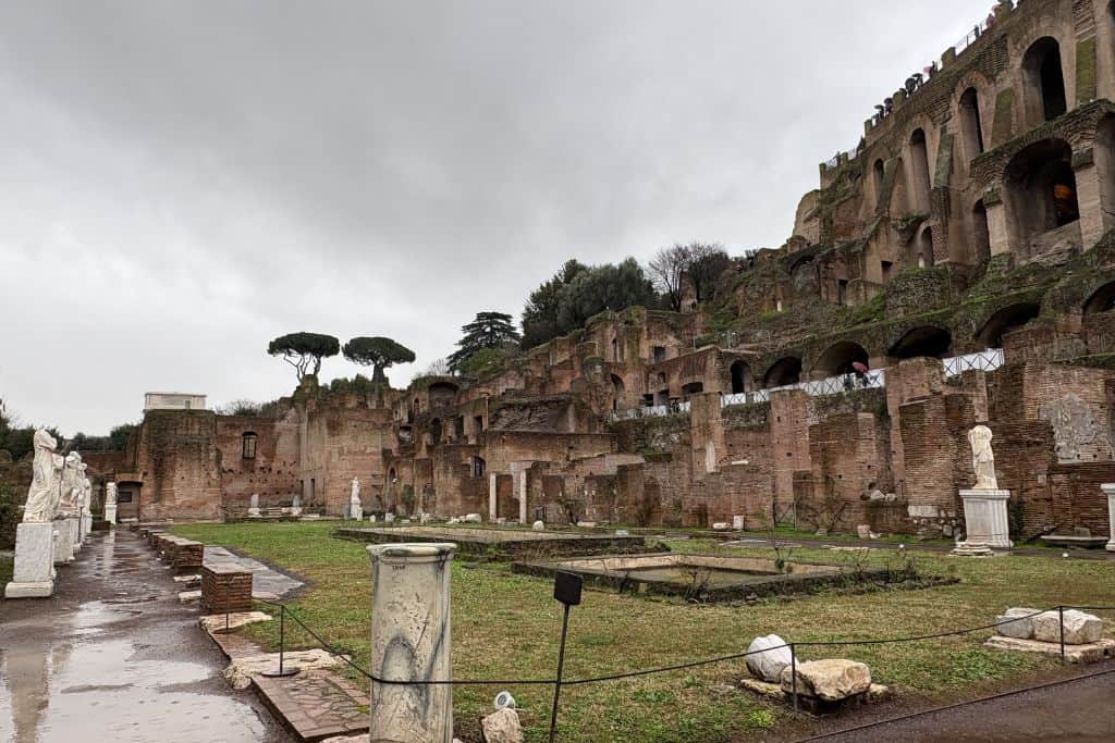 View of ruins in field in Rome like columns and ancient arches