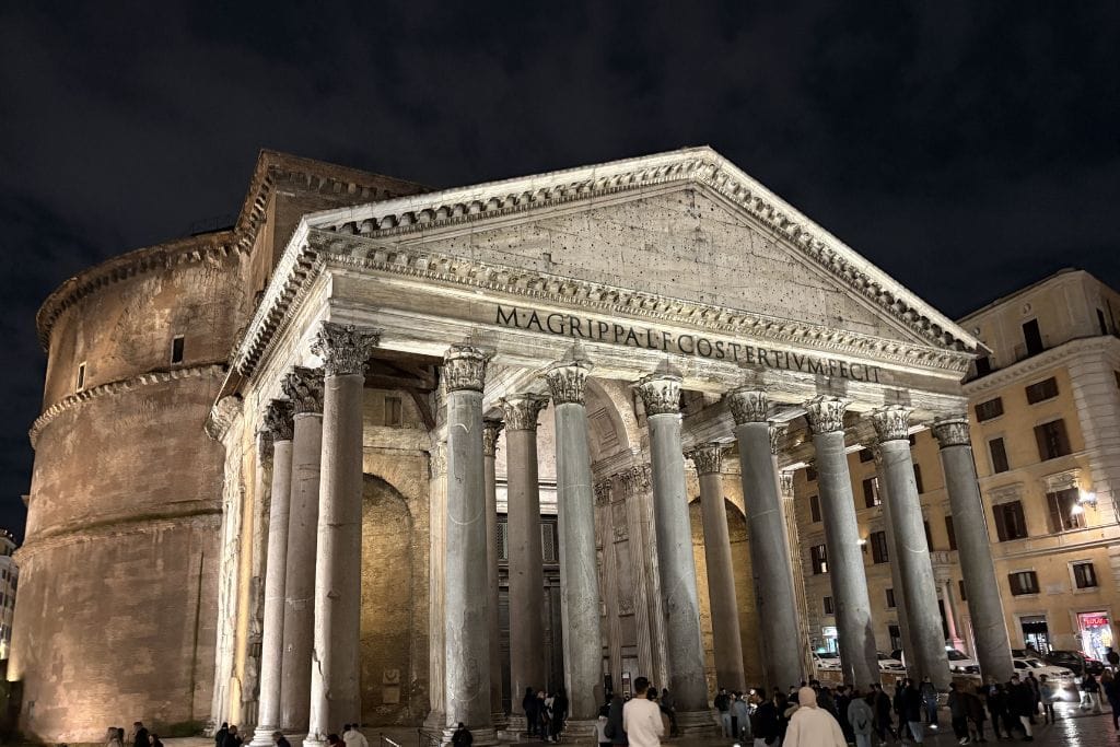 Night view of large ancient monument with columns and spherical ceiling